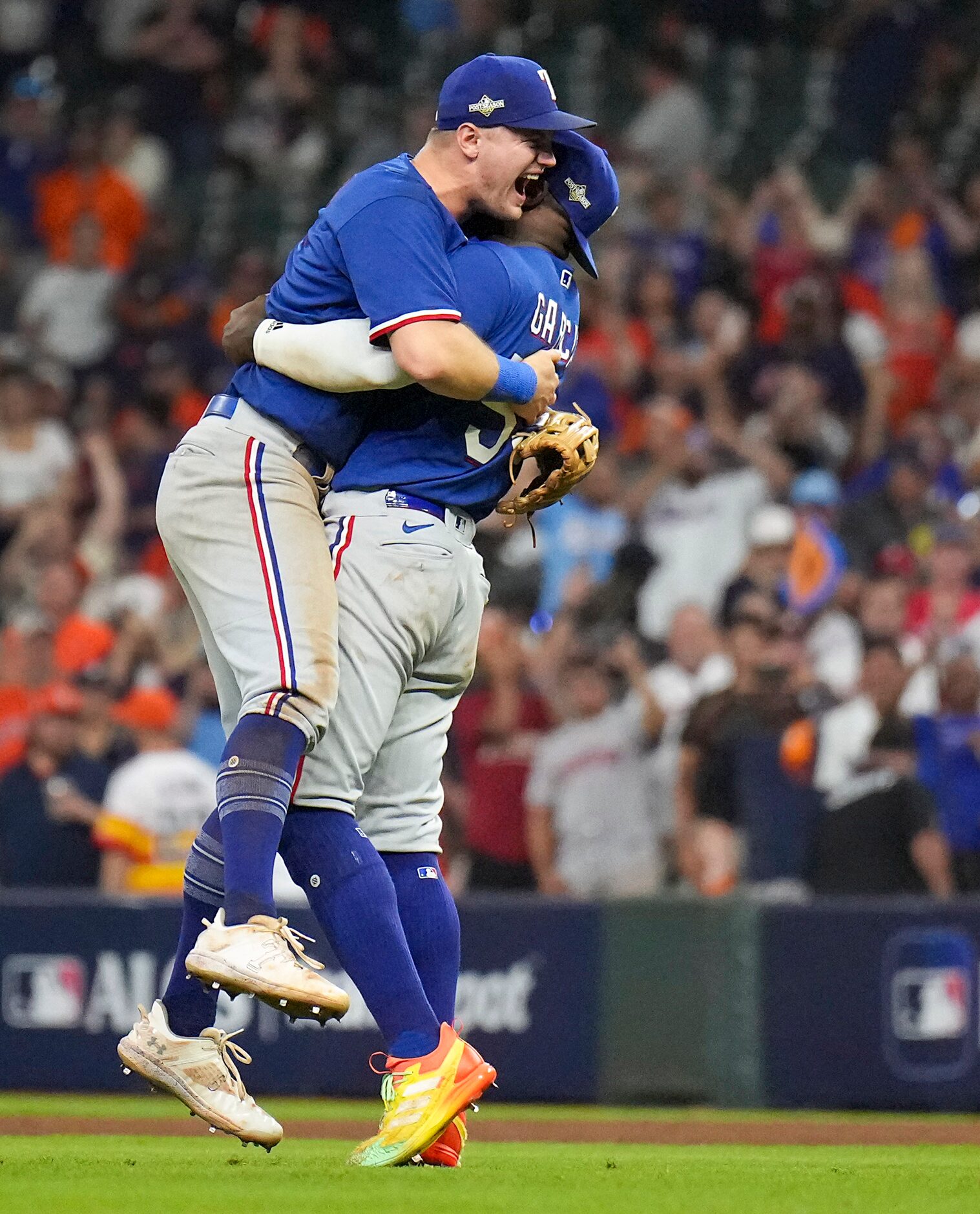 Texas Rangers third baseman Josh Jung celebrates with right fielder Adolis Garcia after the...