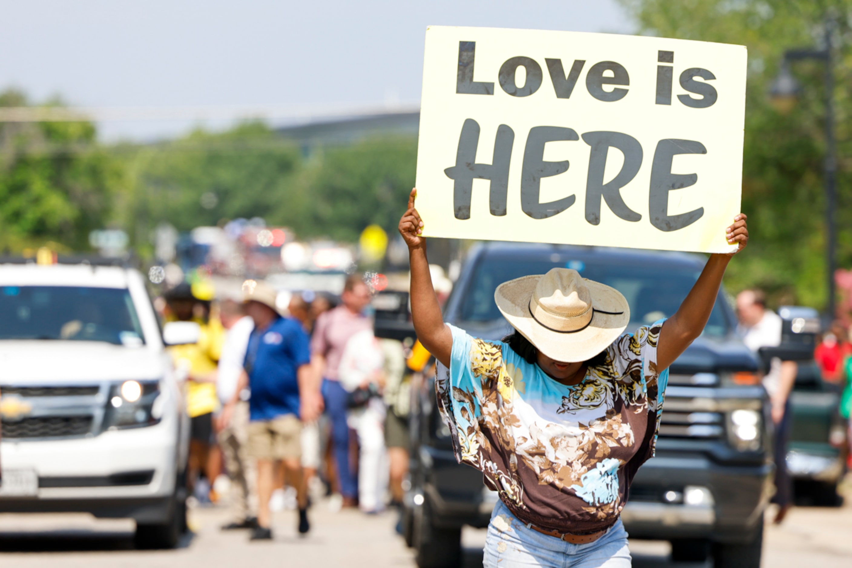 An attendee marches holding a sign ahead of the crowd during Opal's Walk for Freedomon...