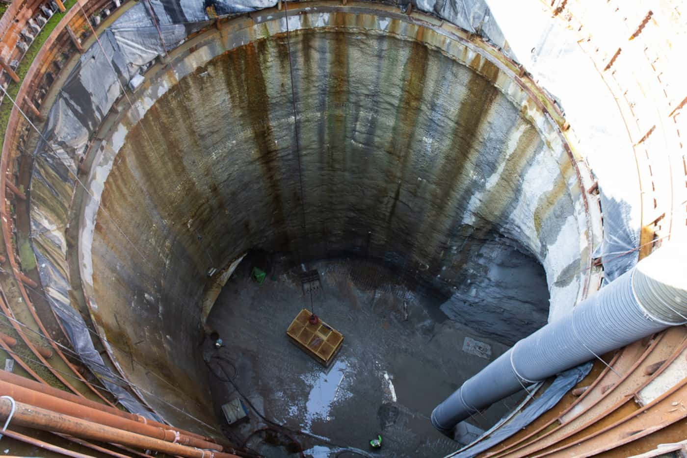 Peeking into the entrance to the drainage tunnel, which lies 120 feet below.