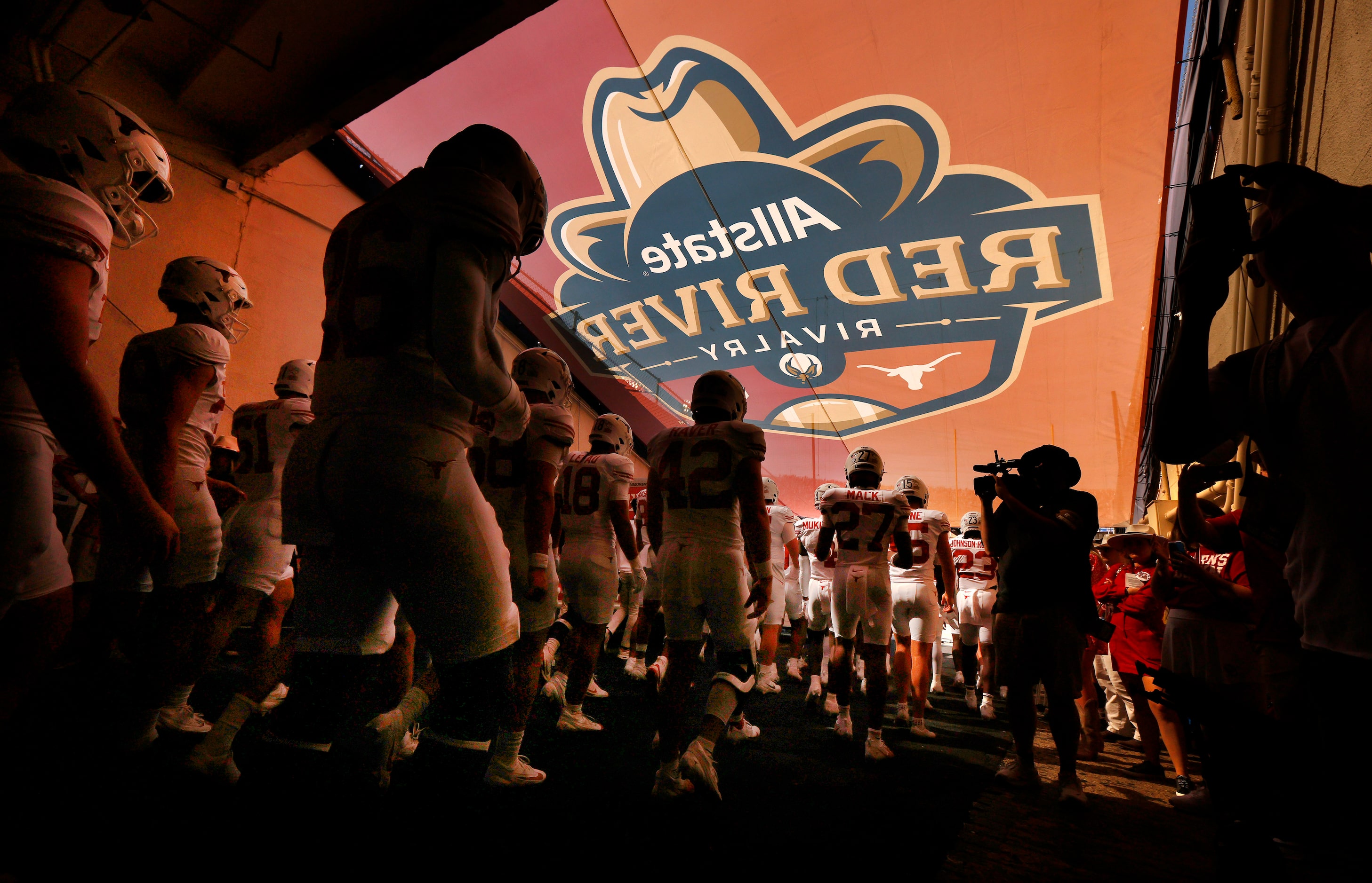 The Texas Longhorns football players walk down the tunnel for the team introduction before...