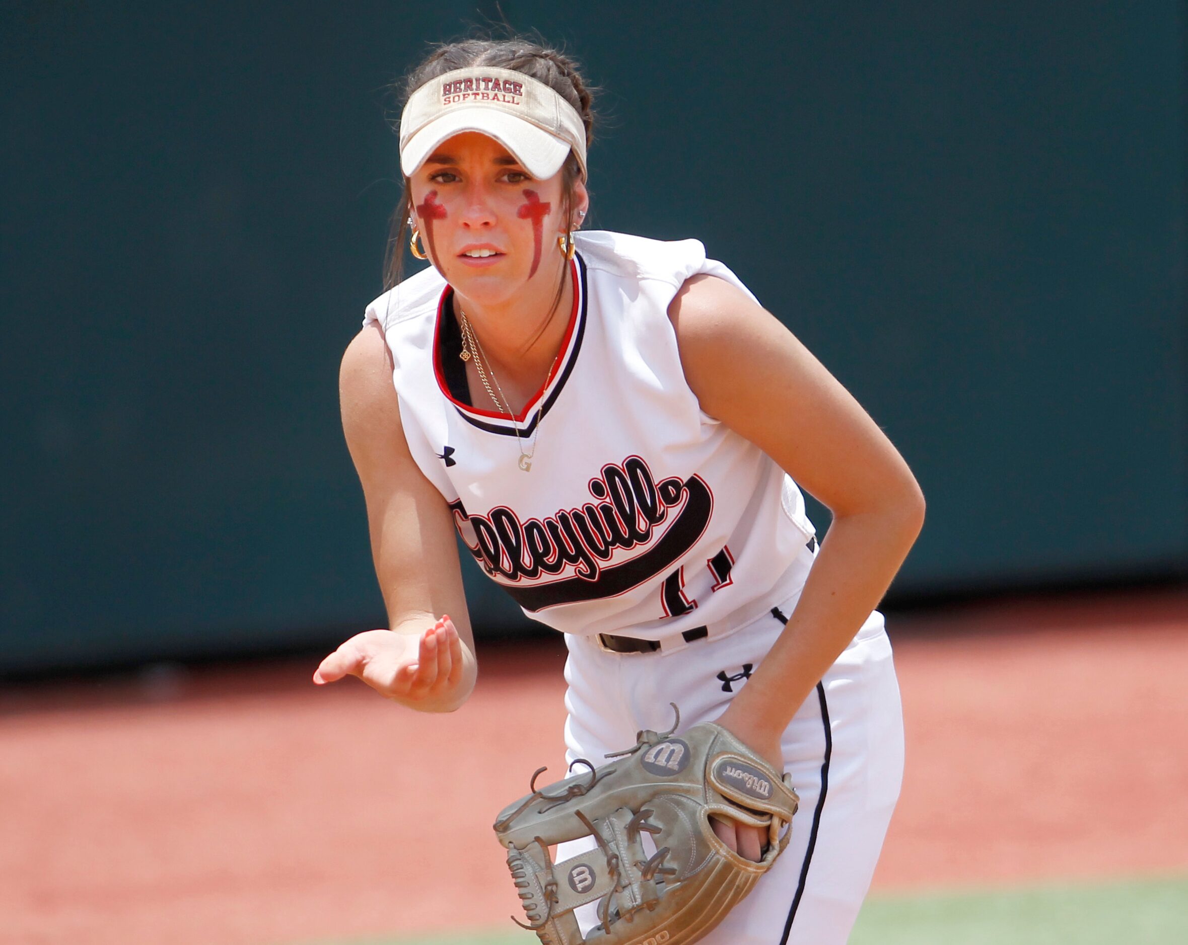 Colleyville Heritage third baseman Graci Green (11) motions for a teammate to move in...