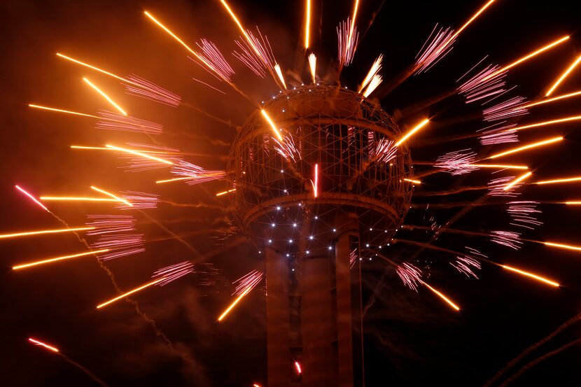 Fireworks fly from Reunion Tower during the New Year's Eve event in Dallas on December 31,...