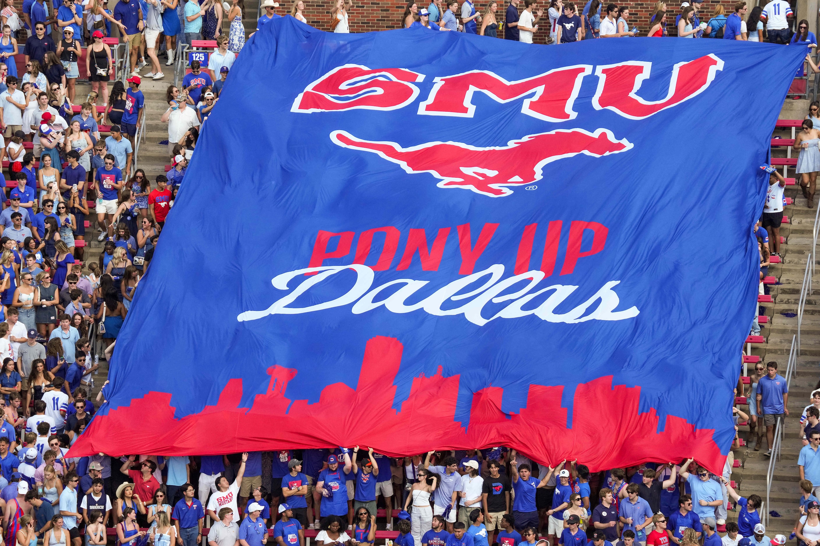 SMU fans unfurl a banner before an NCAA football game against TCU at Ford Stadium on...