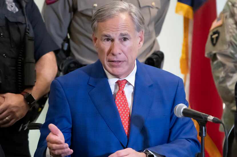 Texas Gov. Greg Abbott answers a question after signing into law a bill more than tripling...