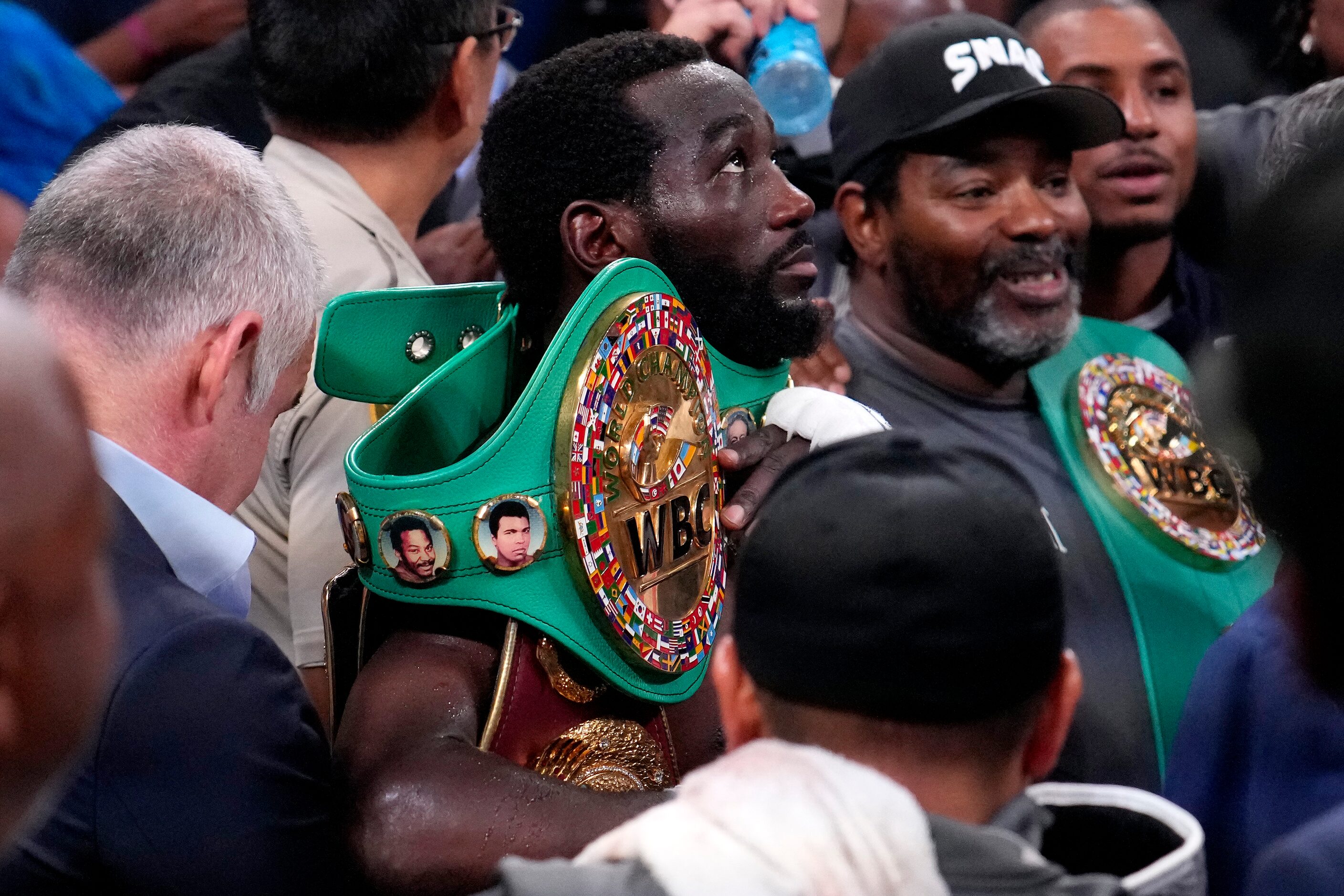 Terence Crawford holds his undisputed welterweight boxing championship belt after defeating...