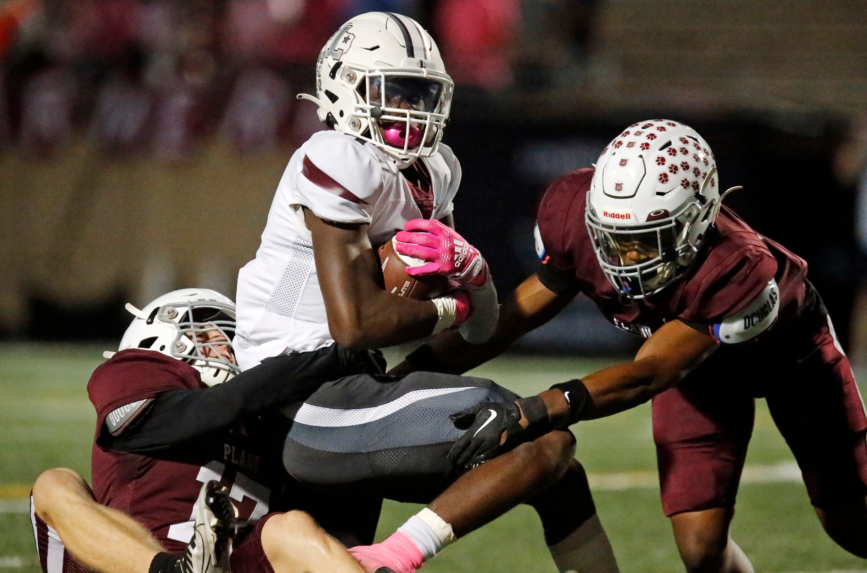 Lewisville High School wide receiver Lamar Kerby (9) is tackled by Plano Senior High School...