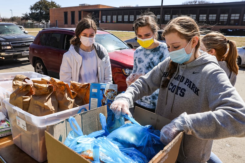 From left, volunteers Ellie Donahoe, 15, Caroline Vallard, 15, and Jullian Miller, 15,...