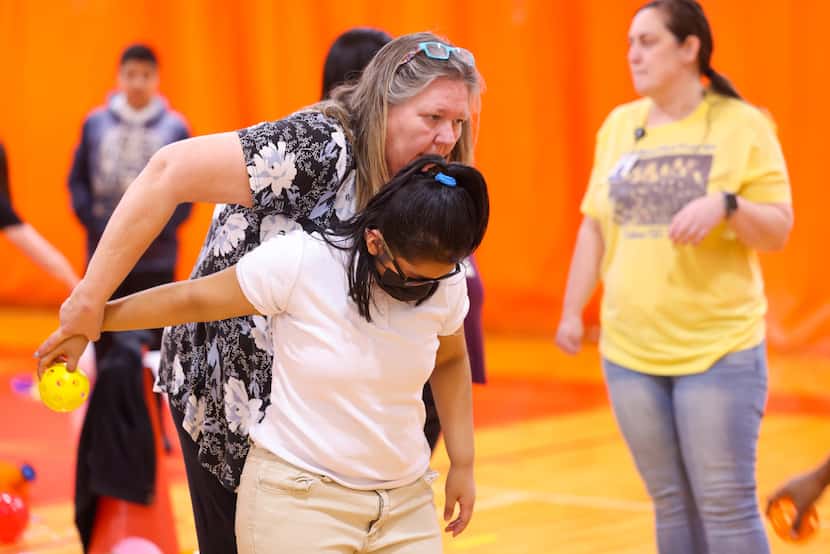 Lisa Gray (left), a teacher of the visually impaired at Dallas ISD, guides Stephanie Perez,...