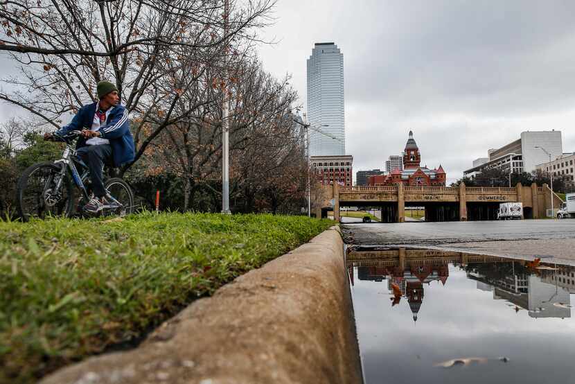 A bicyclist passes by Martyrs Park on Thursday, Jan. 23, 2020 in Dallas. 