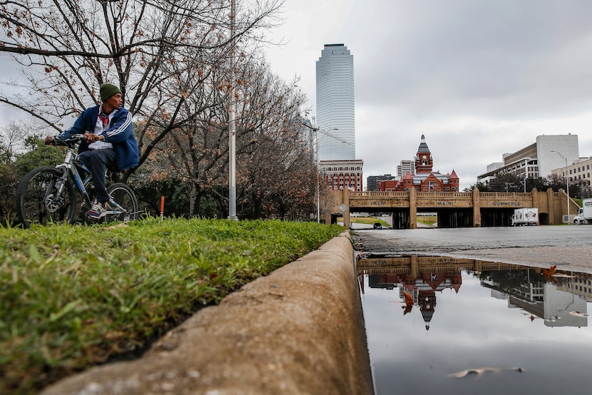 A bicyclist passes by Martyrs Park on Thursday, Jan. 23, 2020 in Dallas. 