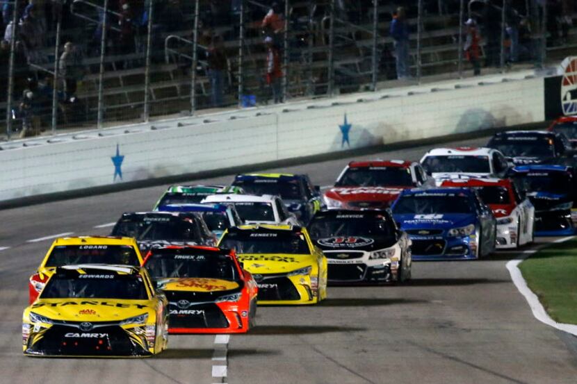 Carl Edwards (19) leads the pack of cars during Duck Commander 500 at Texas Motor Speedway...