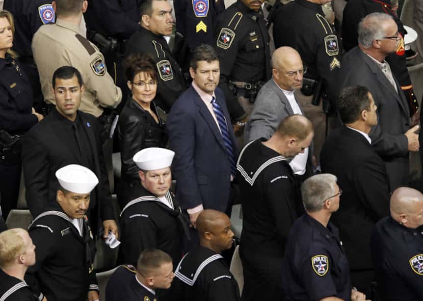 Sarah Palin and  husband Todd Palin (center) waits to exit the field during a memorial...