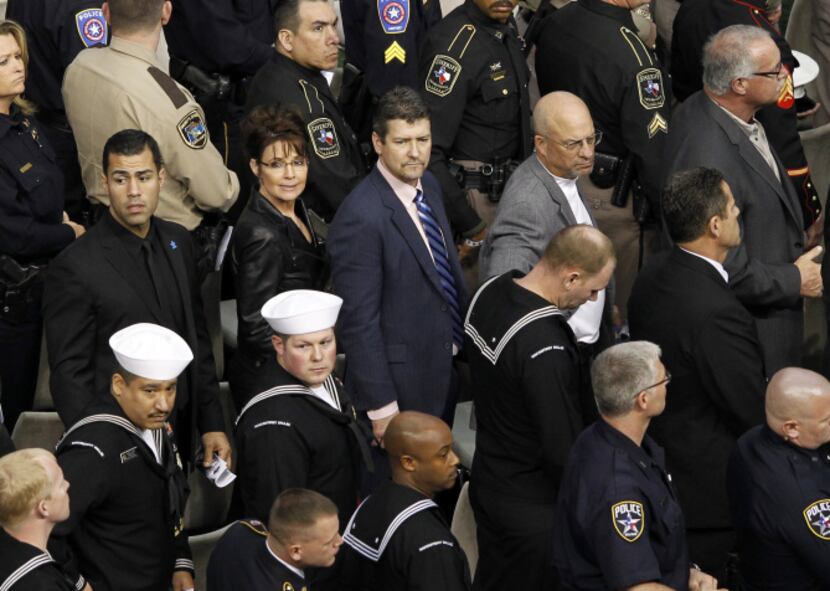 Sarah Palin and  husband Todd Palin (center) waits to exit the field during a memorial...