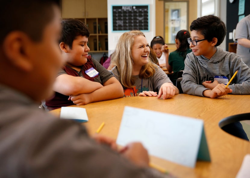 New teacher Caroline Rodgers talks with Brandon Garcia (right) as Brandon Navarr looks on...