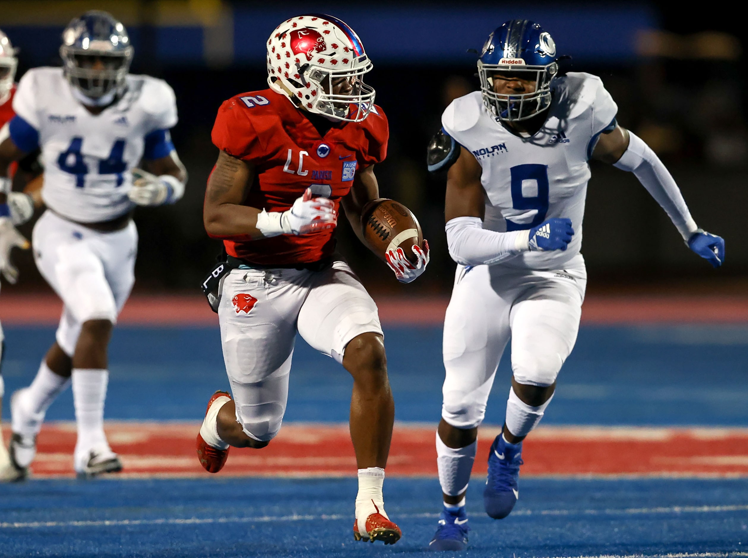 Parish running back Andrew Paul (2) gets past Nolan linebacker Curlee Thomas III (9) and...