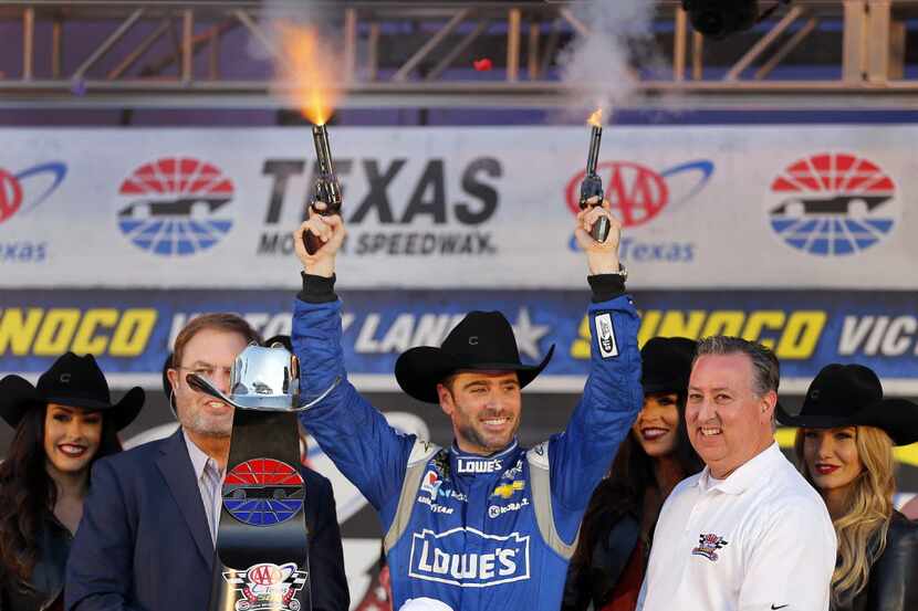 Sprint Cup Series driver Jimmie Johnson (48) celebrates his AAA Texas 500 race win by firing...