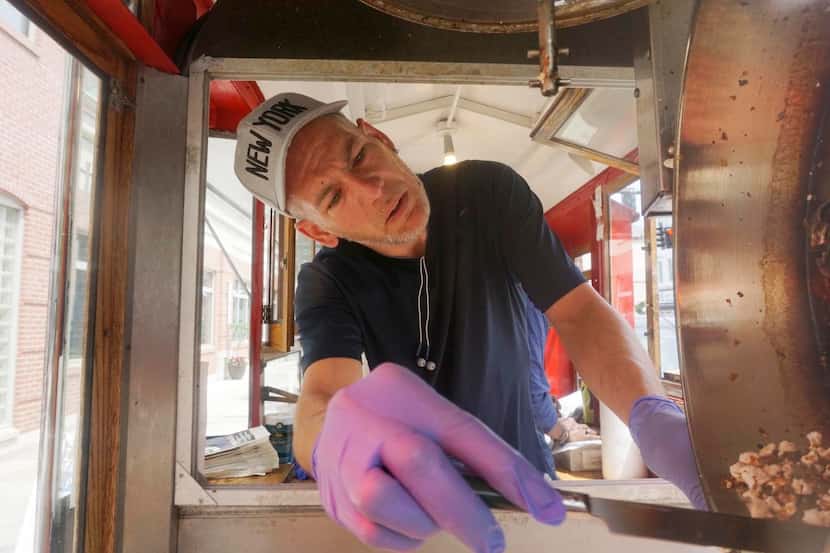 Mark Flannigan makes a batch of popcorn at the Popcorn Wagon in Pittsfield, Mass. The...