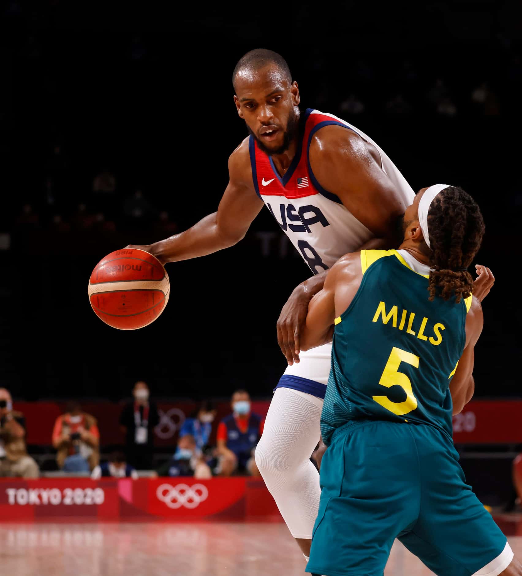 USA’s Khris Middleton (8) posts up Australia’s Patty Mills (5) during the second half of a...