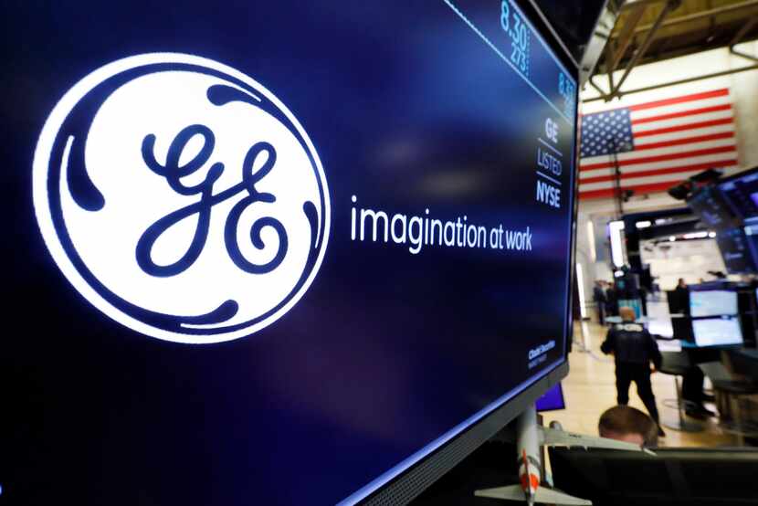 The logo for General Electric appears above a trading post on the floor of the New York...