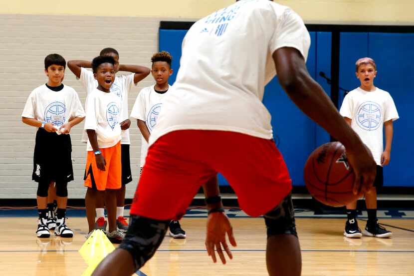 Campers react to NBA Dallas Maverick forward, Harrison Barnes teaching ball handeling skills...