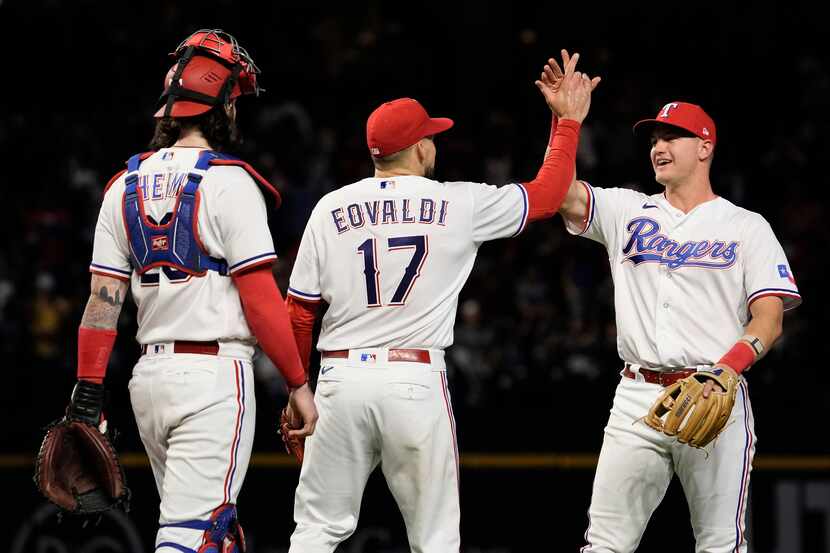 Texas Rangers starting pitcher Nathan Eovaldi (17) is congratulated by third baseman Josh...