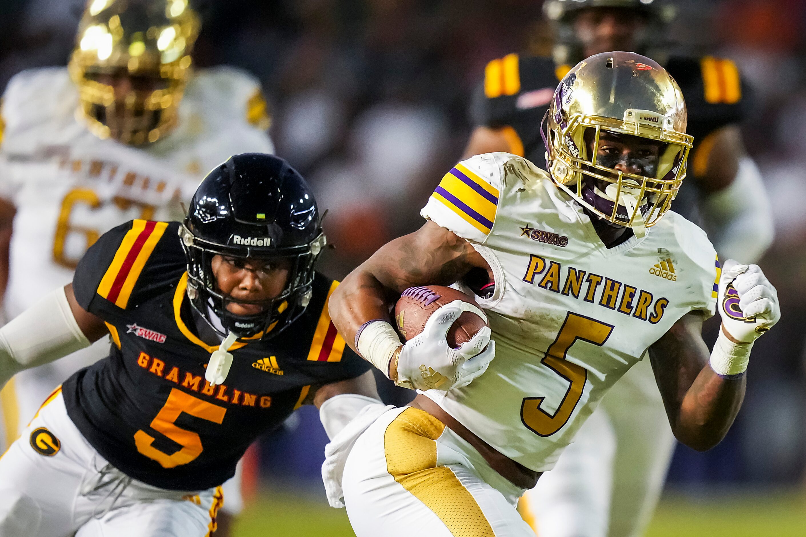 Prairie View running back Ahmad Antoine gets past Grambling defensive back Quincy Mitchell...