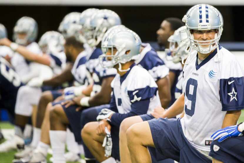 Dallas Cowboys quarterback Tony Romo stretches with teammates during the team's final...