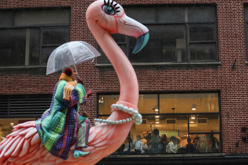 People watch from inside as the Macy's Thanksgiving Day parade goes by, Thursday, Nov. 28,...