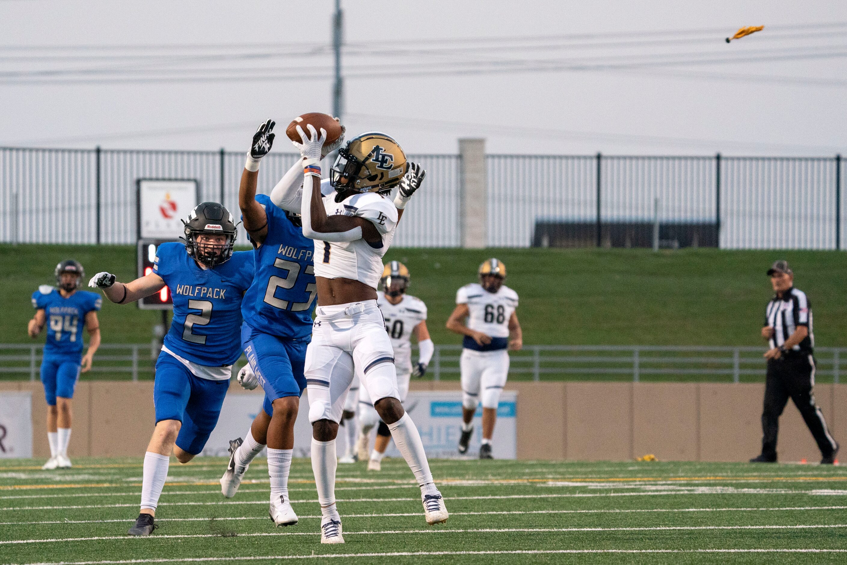 A penalty flag flies in as Little Elm senior wide receiver Josh Joseph (1) makes the catch...