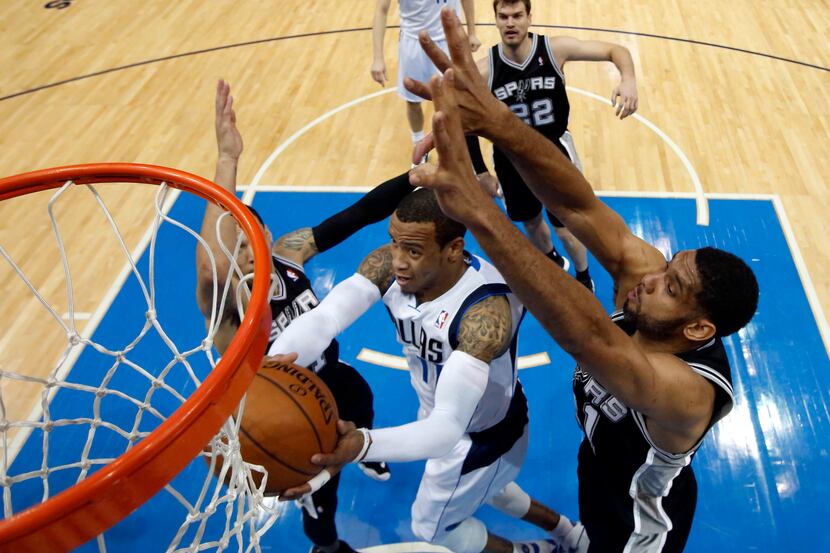 Dallas Mavericks guard Monta Ellis (11) weaves between San Antonio Spurs guard Danny Green...