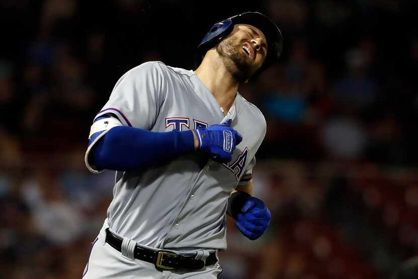 Texas Rangers' Joey Gallo reacts after flying out against the Boston Red Sox during the...