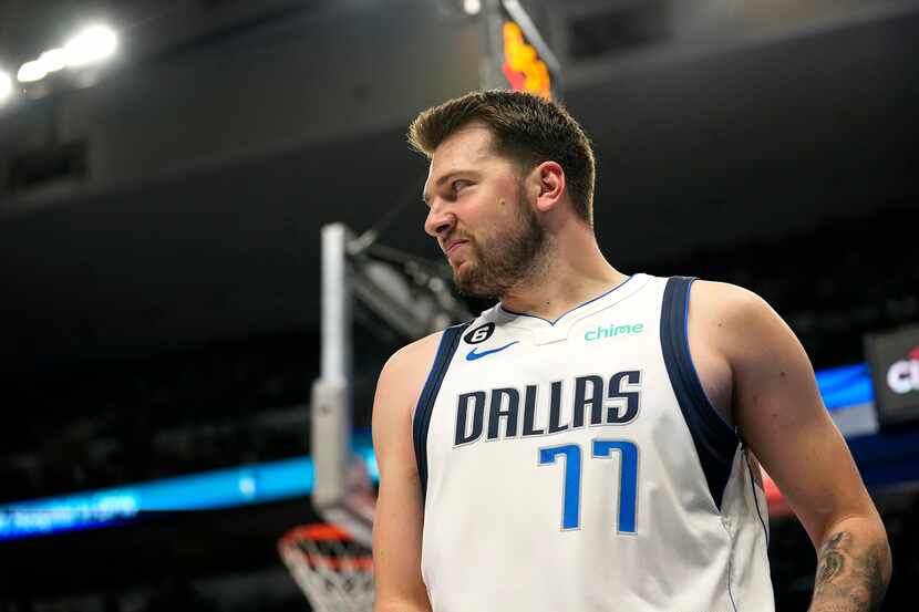 Dallas Mavericks guard Luka Doncic smiles after attempting a basket in the first thalf of an...