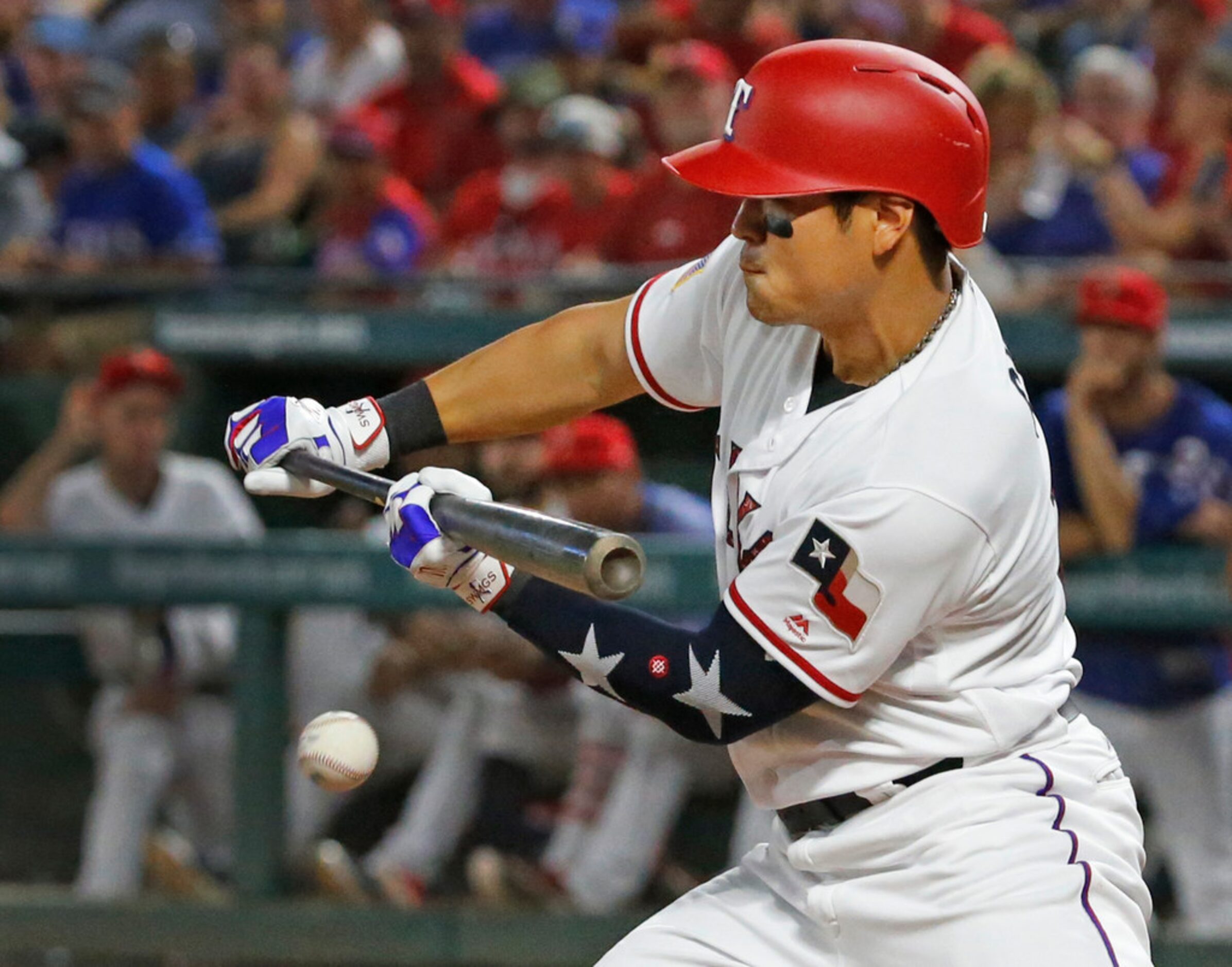 Texas Rangers designated hitter Shin-Soo Choo (17) tries to bunt his way on, but fouls off...