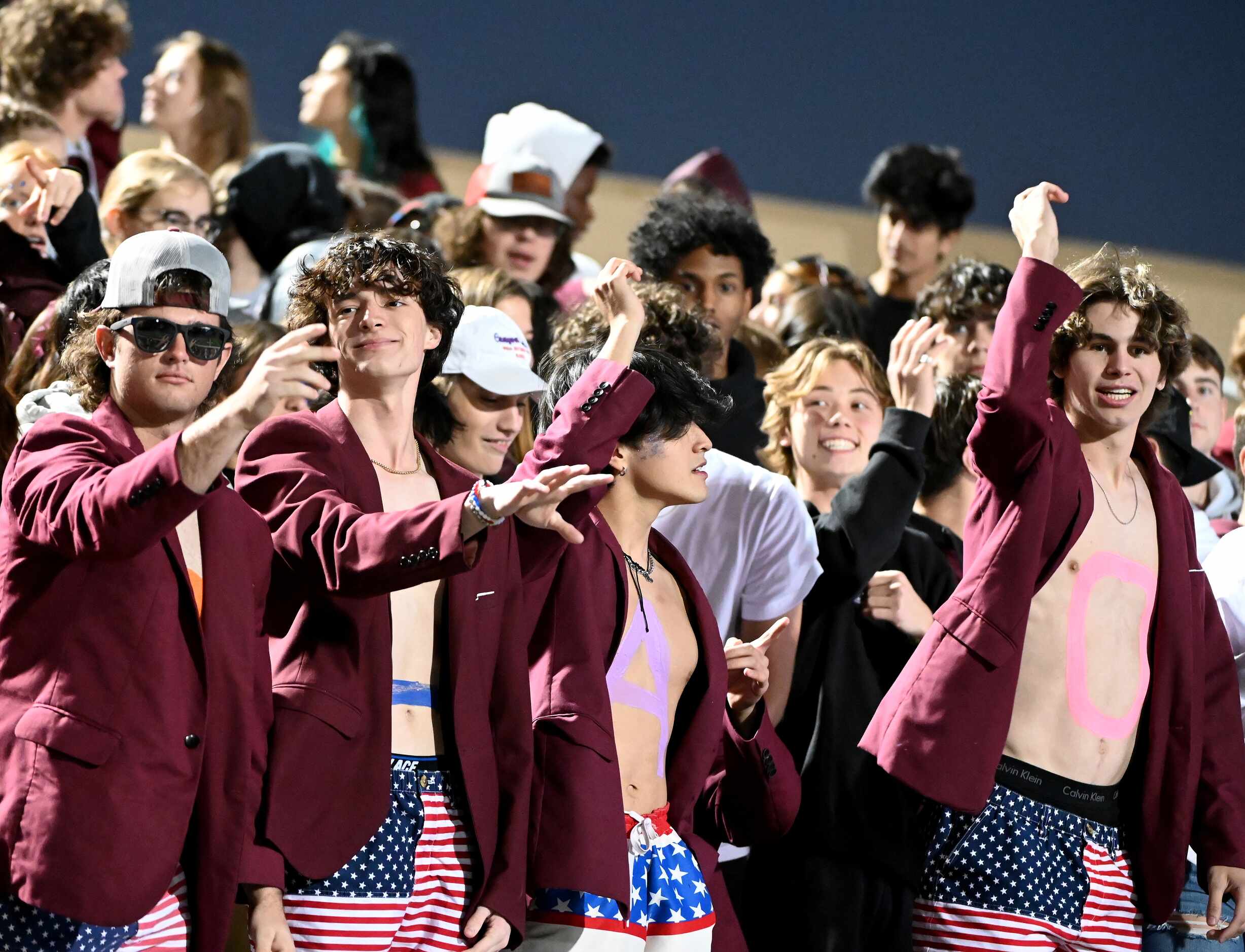 Plano student cheer in the first half of a high school football game between Flower Mound...