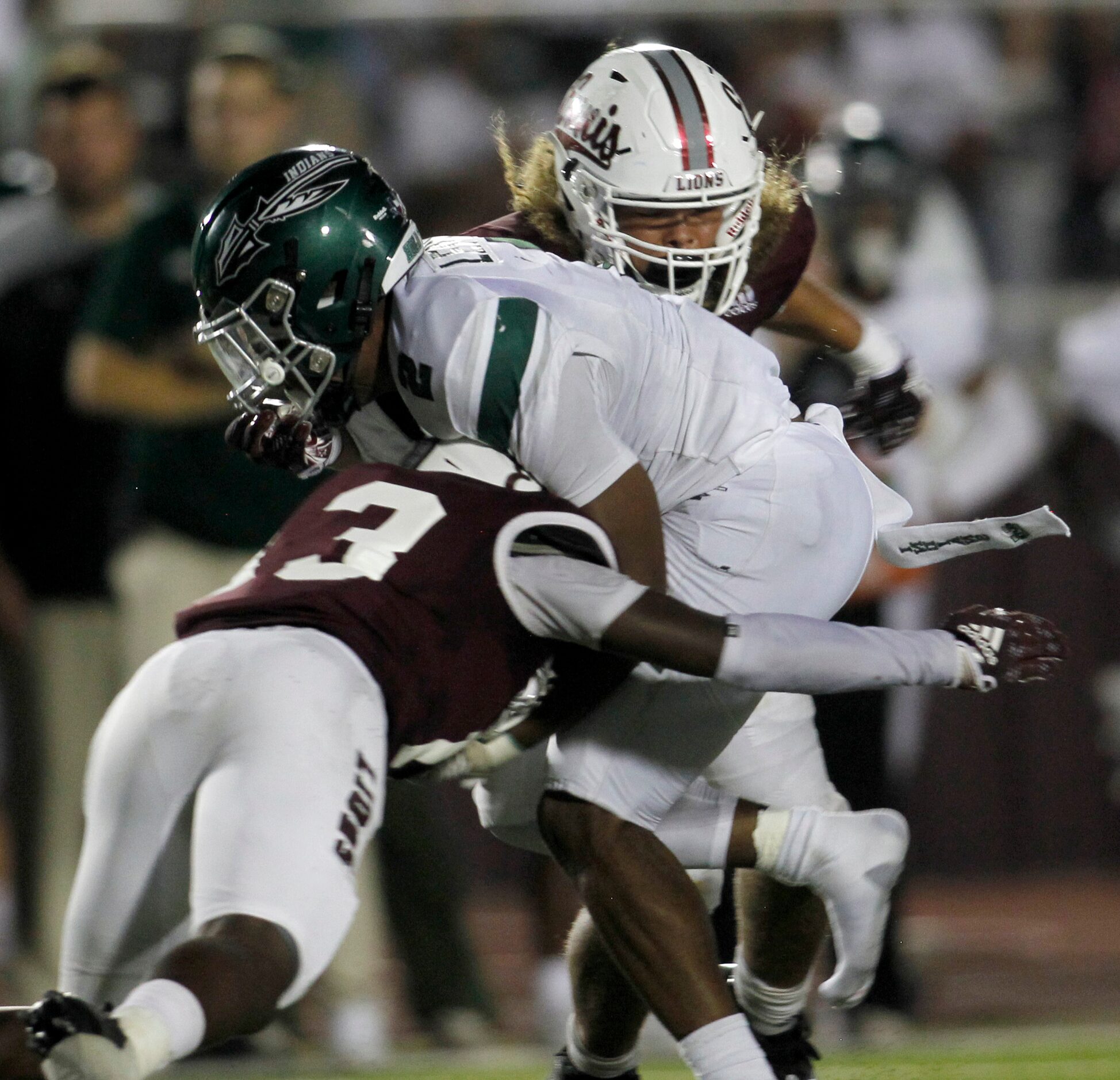 Waxahachie running back Wade Lemons (2) is stopped after a short gain by Waxahachie...