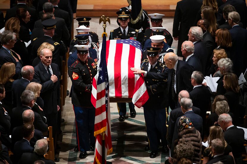 Former Sen. Alan Simpson reached out to touch the flag-draped casket of his friend as a...