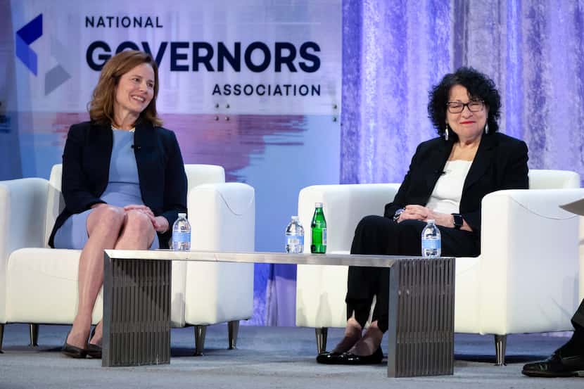 FILE - Supreme Court Justices Amy Coney Barrett, left, and Sonia Sotomayor speak with...