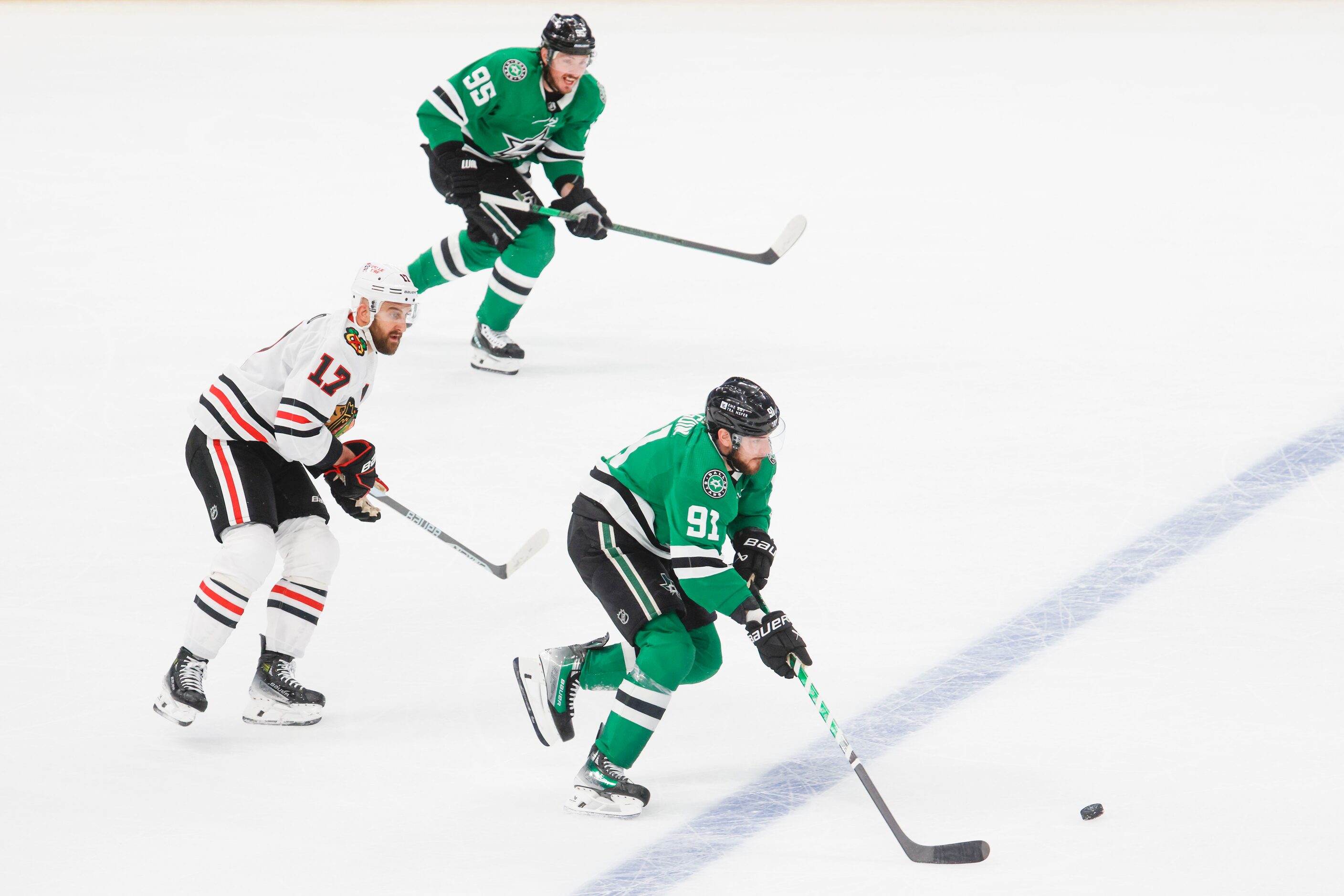 Dallas Stars center Tyler Seguin (91) goes down the rink past Chicago Blackhawks left wing...