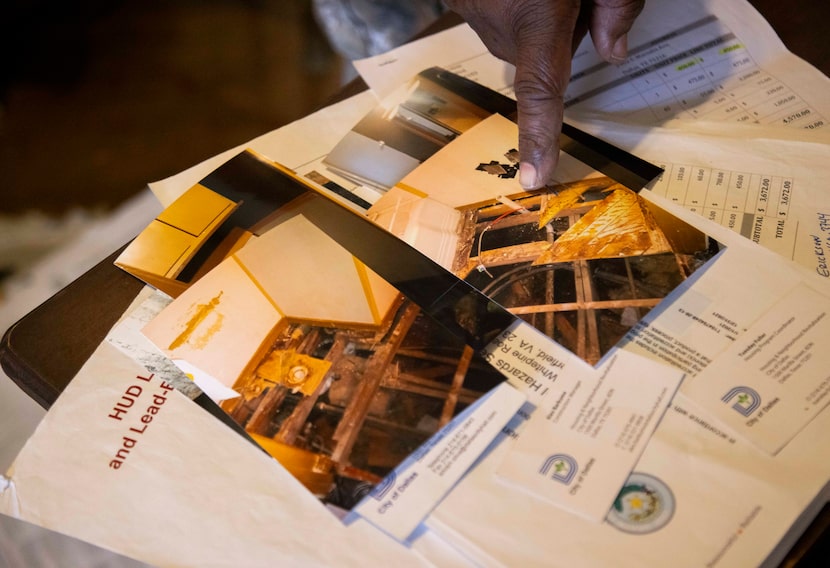 Loucious Miller's points to photos of his bathroom taken when repairs were being made by the...