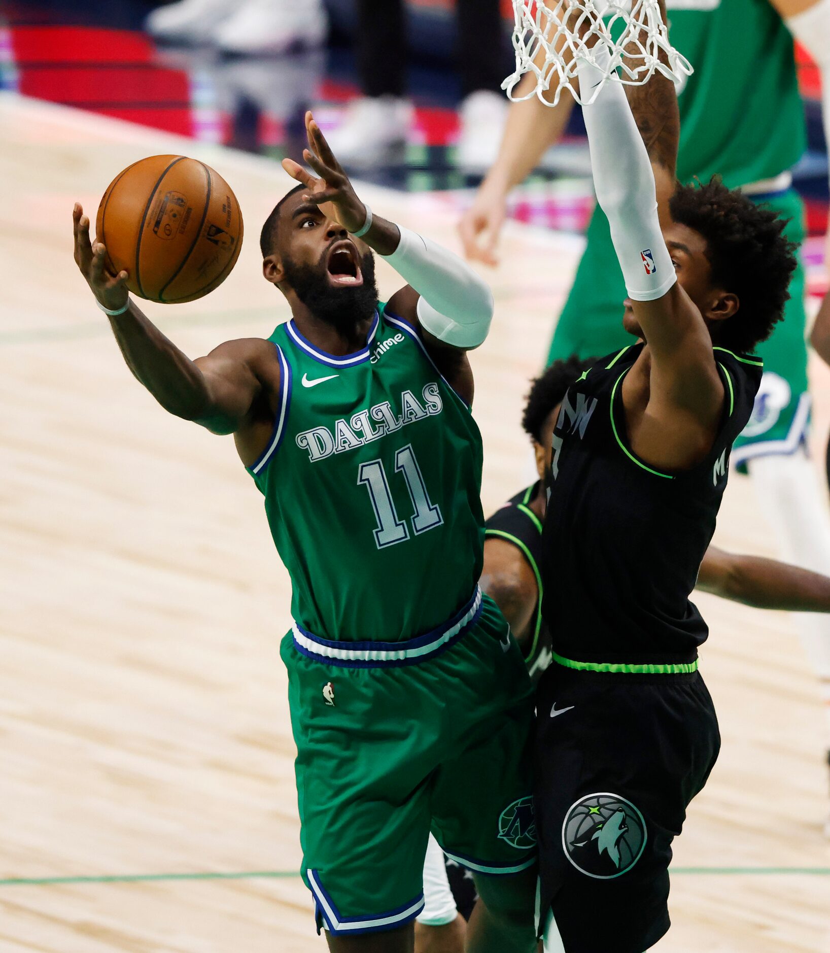 Dallas Mavericks guard Tim Hardaway Jr. (11) attempts a shot in front of Minnesota...