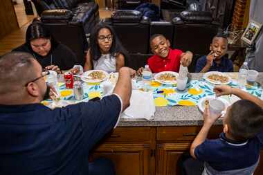 Claudio Sanchez, left and counter-clockwise, sits down to share dinner with his son Daniel,...