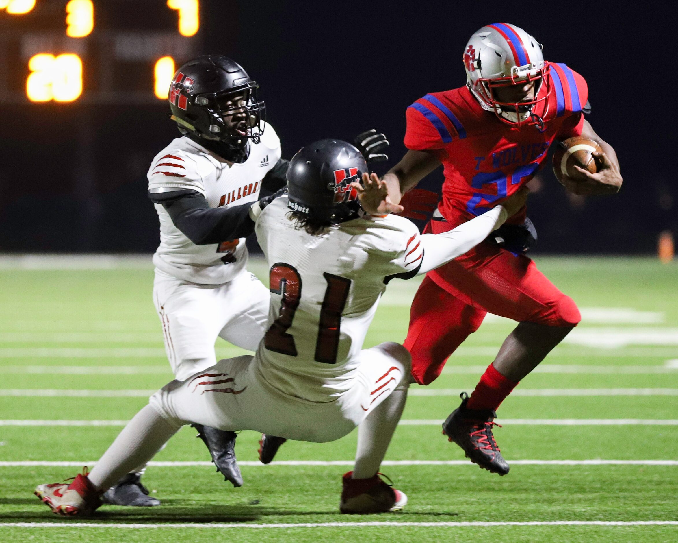 Hillcrest linebacker Collin Dusek (21) and defensive back Nasir Reynolds (4) tackle Spruce...