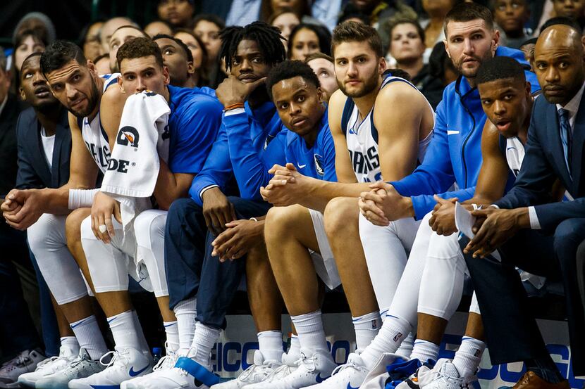 The Dallas Mavericks bench watches during the second half of an NBA basketball game against...
