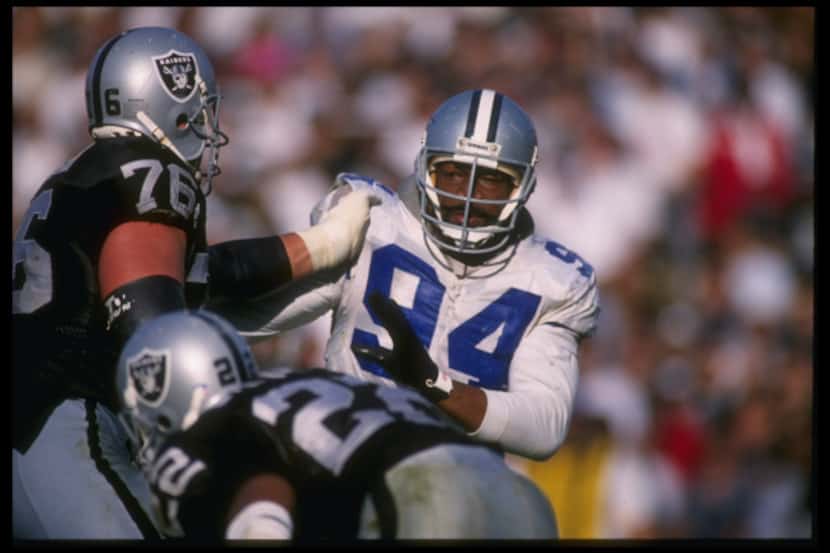 Defensive lineman Charles Haley of the Dallas Cowboys attempts to break through the block of...