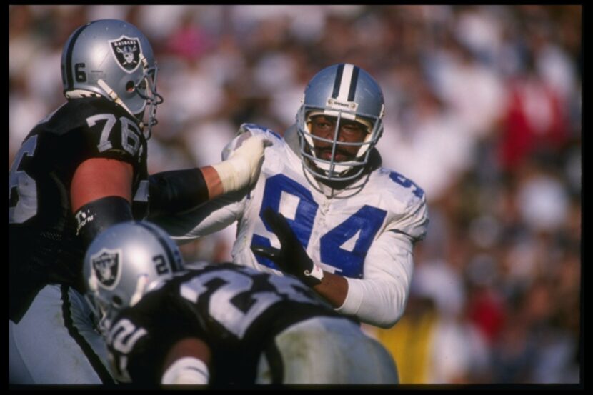 Defensive lineman Charles Haley of the Dallas Cowboys attempts to break through the block of...