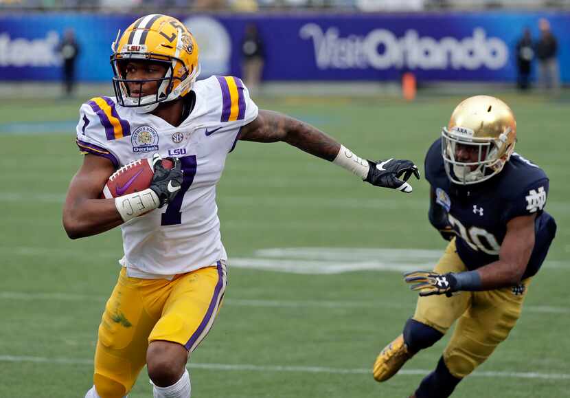 FILE - LSU wide receiver D.J. Chark (7) runs past Notre Dame cornerback Shaun Crawford...