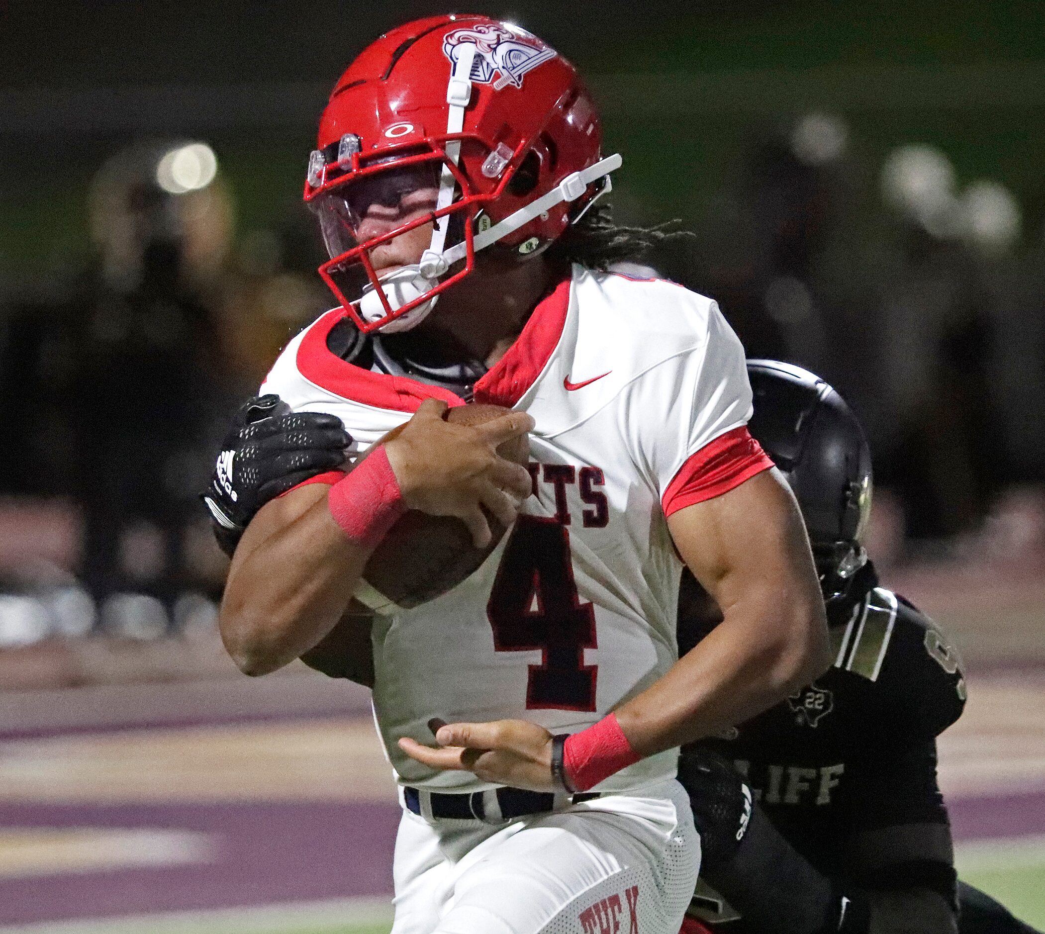 Kimball High School quarterback Armirie Williams-Hall (4) is caught by South Oak Cliff High...