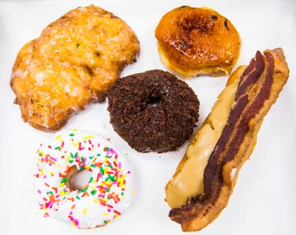 Here's a look at a few Rise Biscuits Donuts items. From clockwise: an apple fritter, a creme...