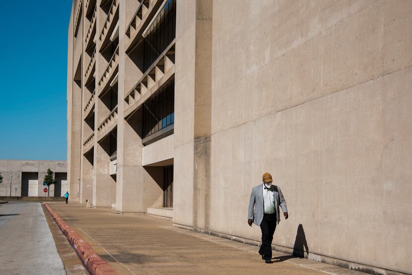 A citizen walks outside of Dallas City Hall in September 2021.