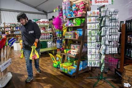 Cristian Salas moves potting soil at North Haven Gardens in North Dallas. 